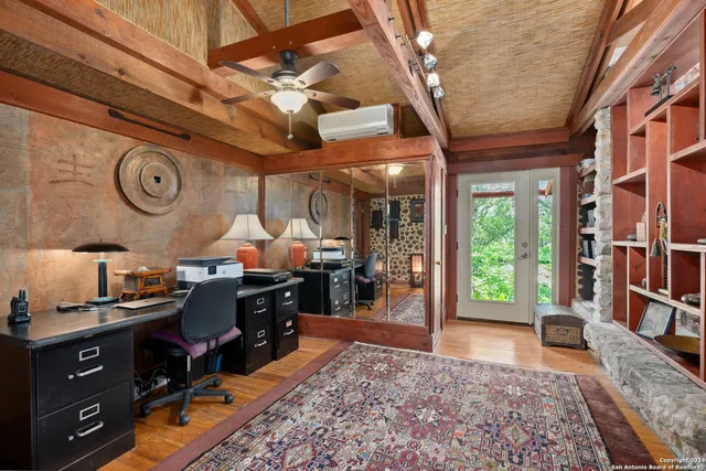 a bedroom with a bed and wooden floor