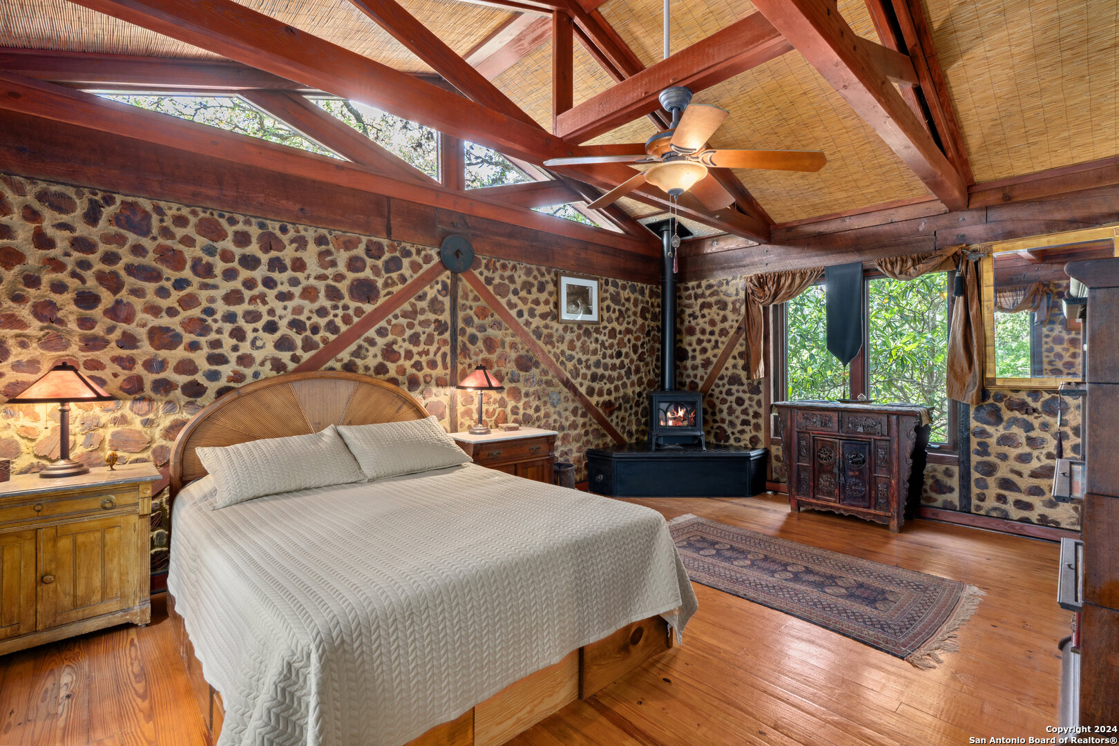 801 Mickle Creek Road Medina, TX 78055 - Photo 35 of 55 a bedroom with a bed and wooden floor