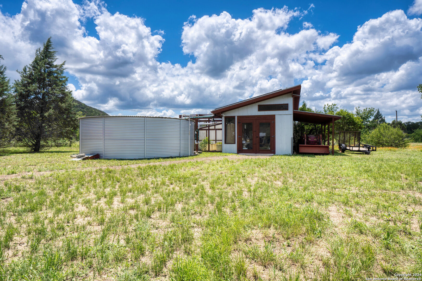 801 Mickle Creek Road Medina, TX 78055 - Photo 43 of 55 a view of a house with a yard and garage