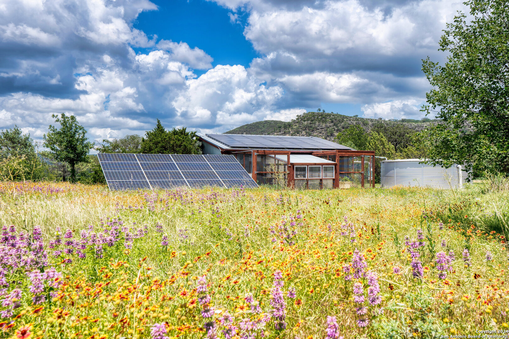801 Mickle Creek Road Medina, TX 78055 - Photo 44 of 55 a view of a garden with a bench in the garden