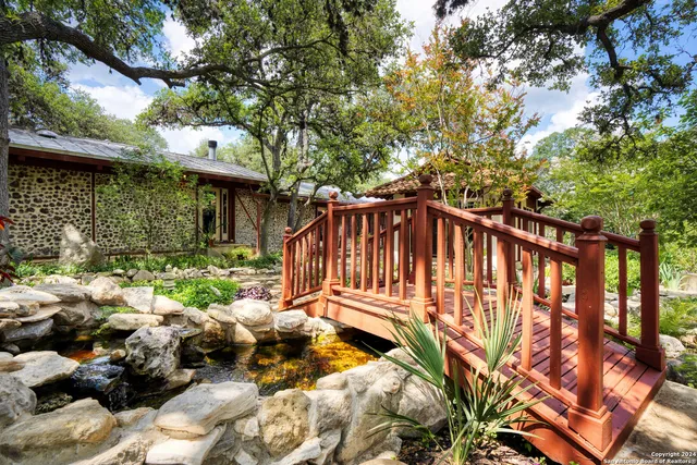 a view of backyard with a table and chairs and wooden fence