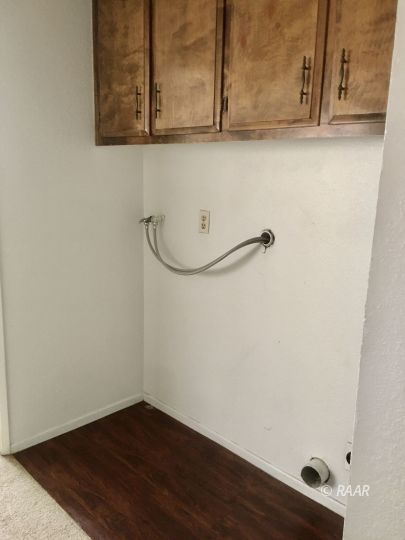 220 South Valley Street Ridgecrest, CA 93555 - Photo 10 of 17 a view of a utility room with wooden floor and cabinets