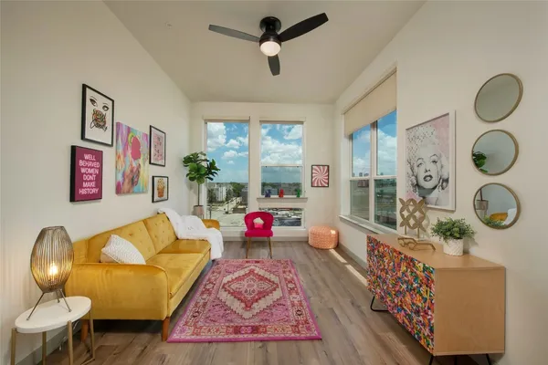 a living room with furniture and a chandelier