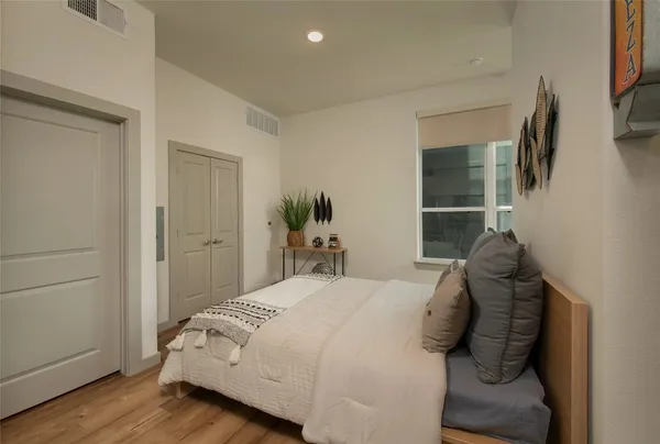 a bedroom with a bed and window