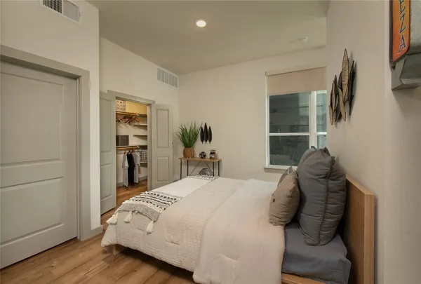 a large bed sitting in a bedroom next to a window