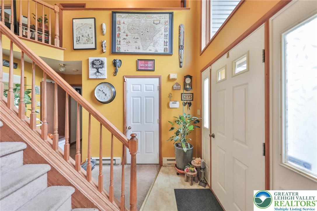 4608 Pine Ridge Drive West Bushkill, PA 18324 - Photo 7 of 62 A welcoming entryway with a staircase leading to the upper level.