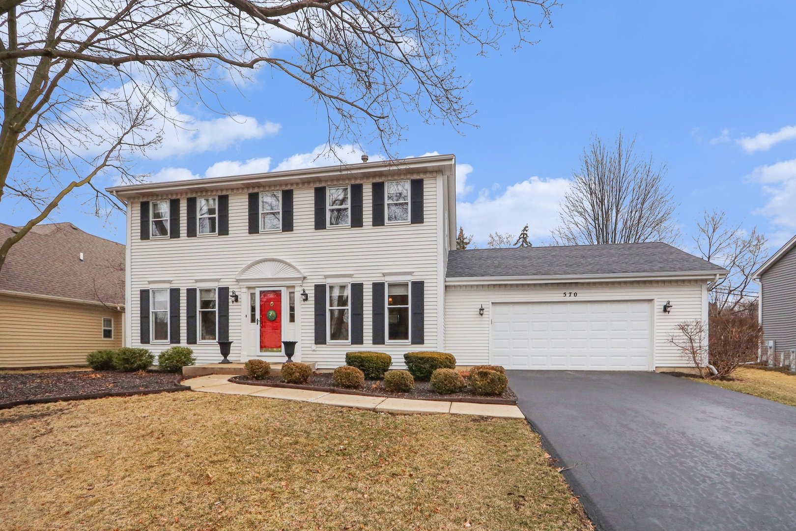 570 Violet Lane Batavia, IL 60510 - Photo 1 of 28 a view of a white house with large windows and a tree