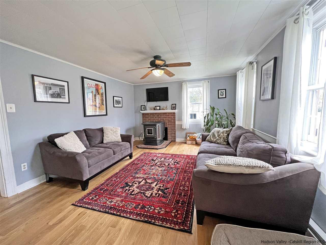 3472 Cooper Street Stone Ridge, NY 12484 - Photo 16 of 34 a living room with furniture a flat screen tv and a fireplace