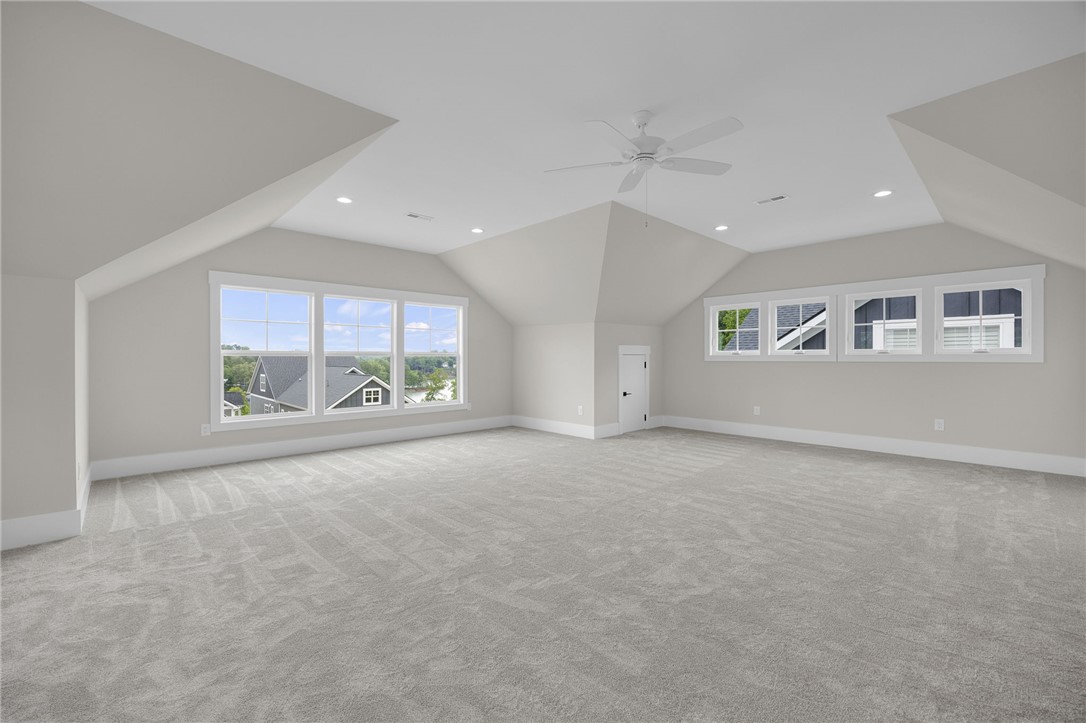 1230 Melton Road, Unit 216 West Union, SC 29696 - Photo 27 of 49 A spacious, naturally illuminated room boasts sloped ceilings, plush carpeting, and recessed lighting.