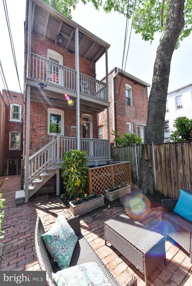 308 11th Street Southeast Washington, DC 20003 - Photo 12 of 30 a view of a patio with couches table and chairs and wooden fence