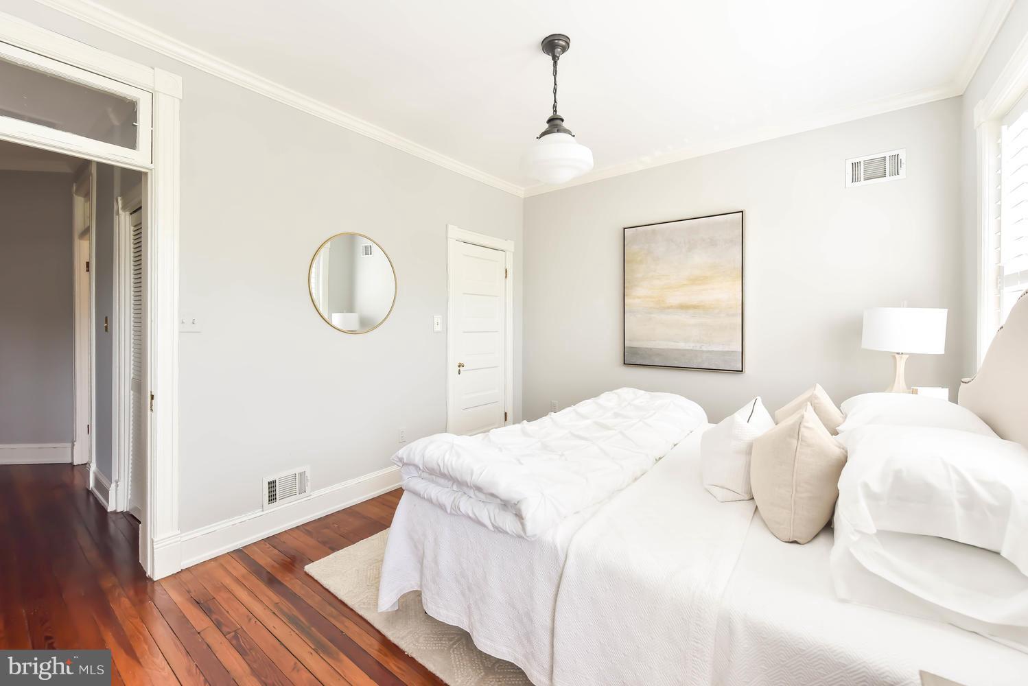 308 11th Street Southeast Washington, DC 20003 - Photo 17 of 30 a bedroom with a bed and wooden floor