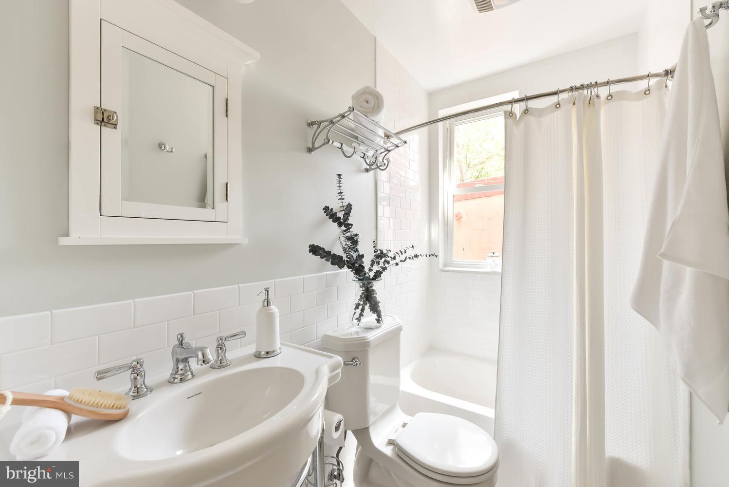 308 11th Street Southeast Washington, DC 20003 - Photo 20 of 30 a bathroom with a sink a toilet and a mirror
