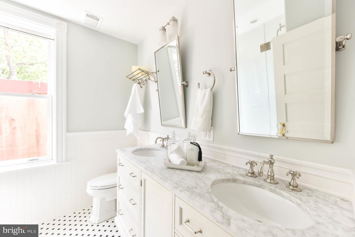 308 11th Street Southeast Washington, DC 20003 - Photo 23 of 30 a bathroom with a granite countertop sink and a mirror