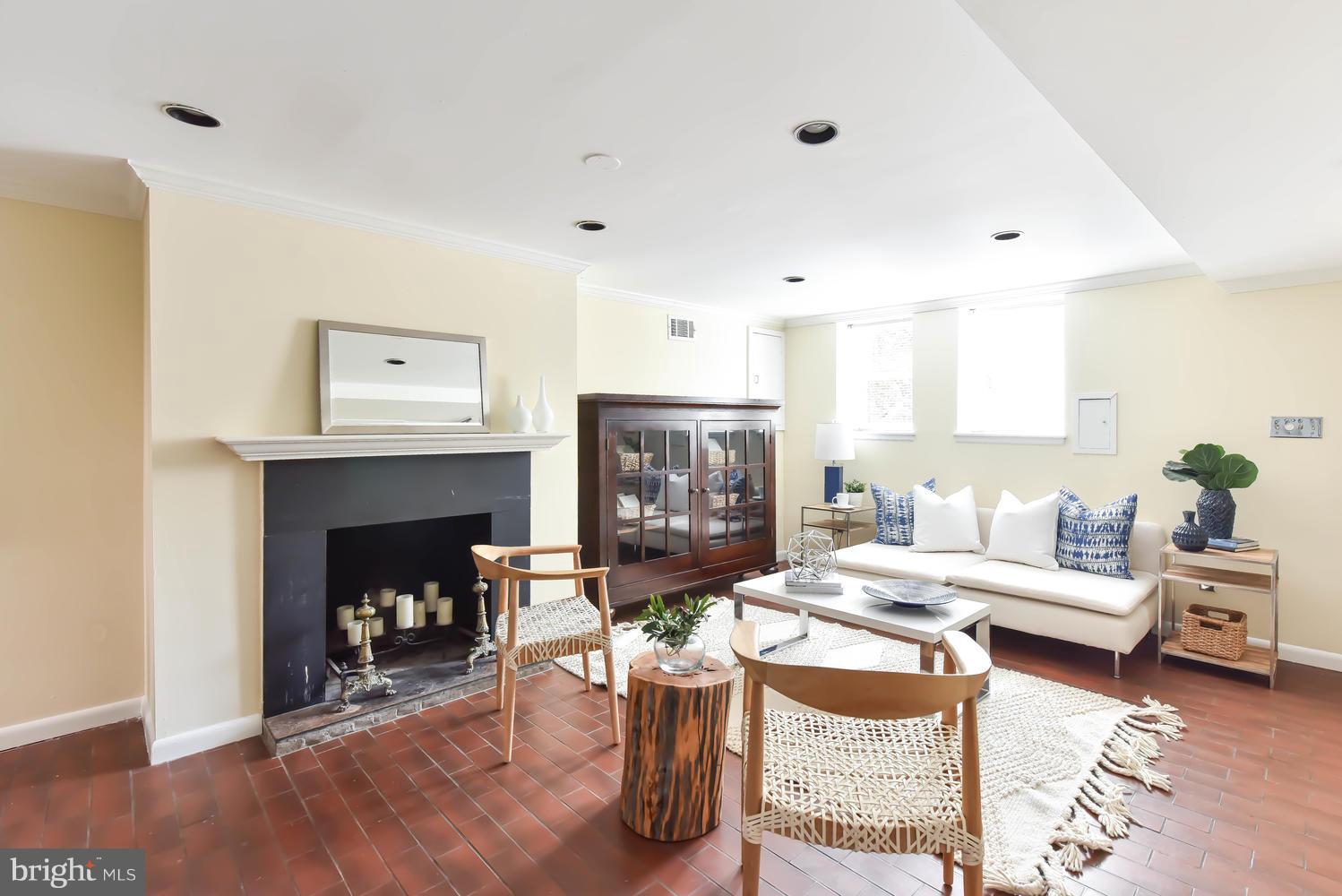 308 11th Street Southeast Washington, DC 20003 - Photo 25 of 30 a living room with furniture and a fireplace