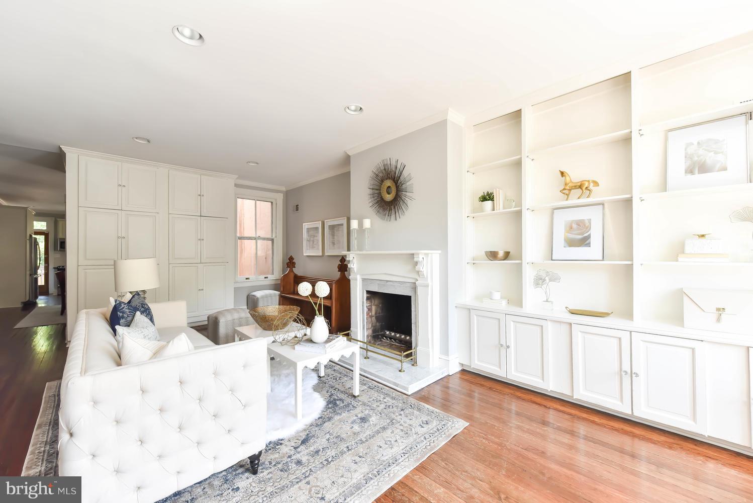 308 11th Street Southeast Washington, DC 20003 - Photo 4 of 30 a living room with furniture a fireplace and a table