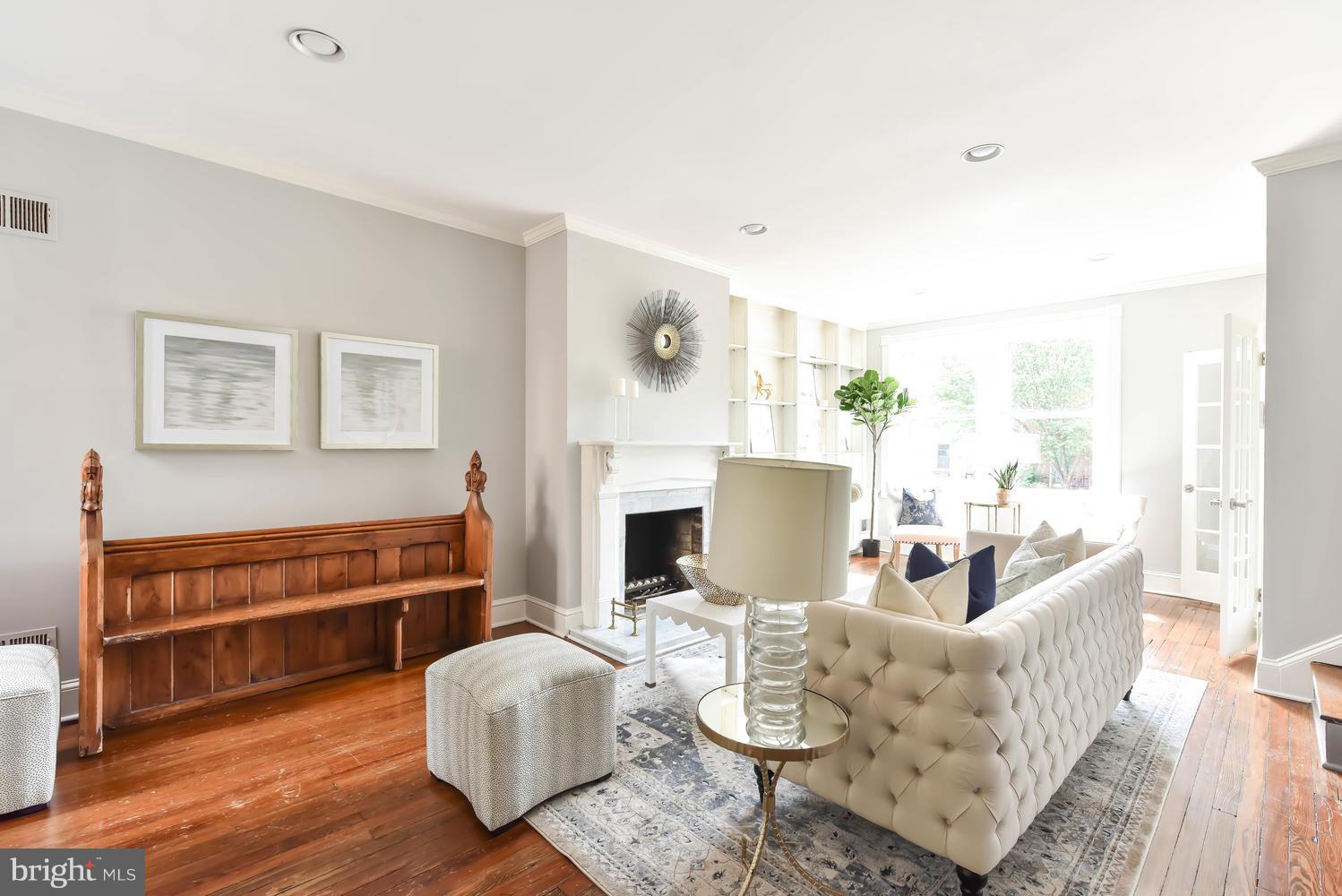 308 11th Street Southeast Washington, DC 20003 - Photo 6 of 30 a living room with furniture a fireplace and a large window