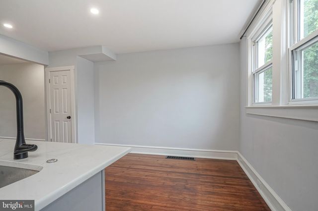 a view of wooden floor and entryway in a room