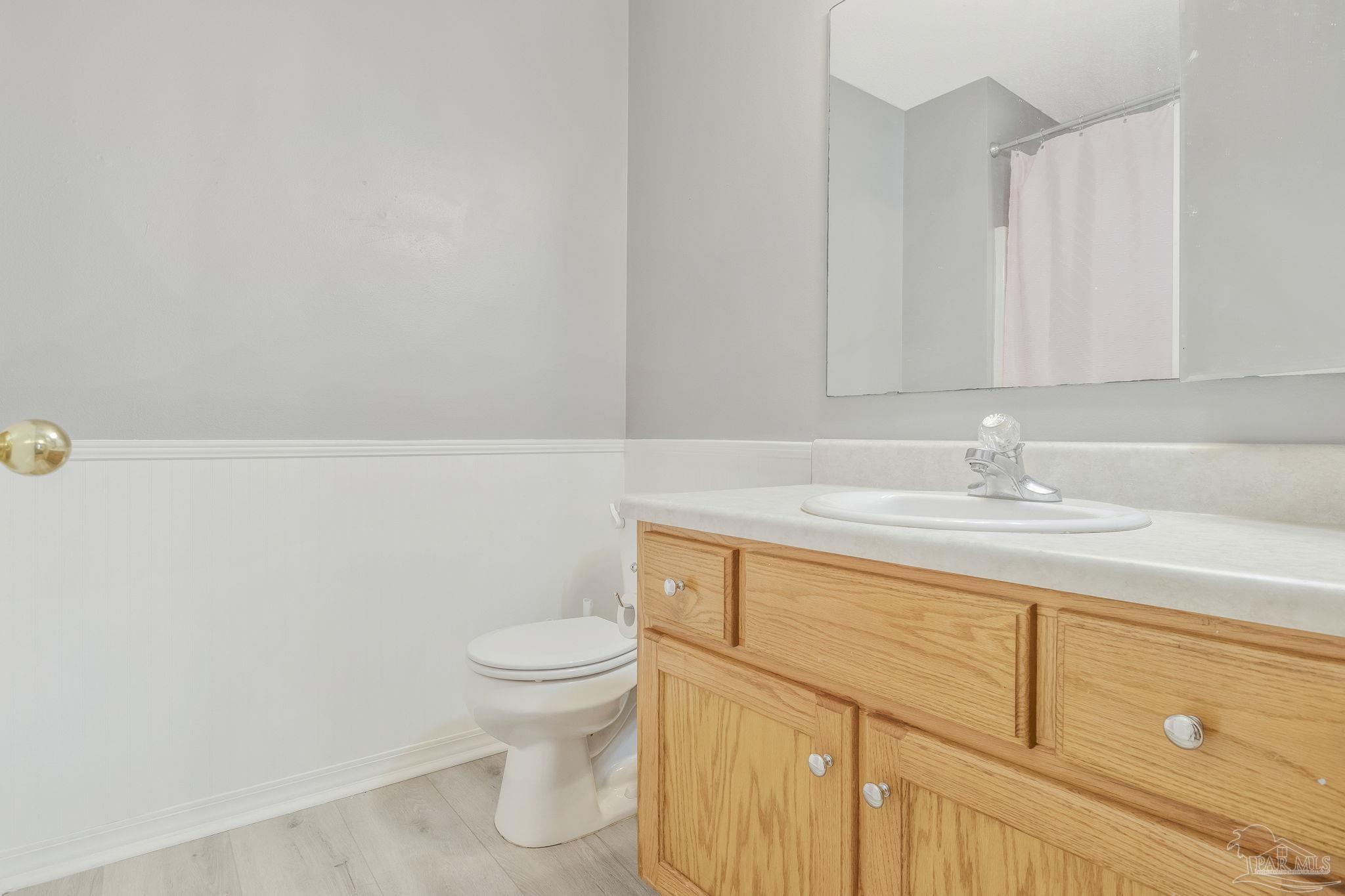 5539 Windrun Place Pace, FL 32571 - Photo 28 of 62 a bathroom with a sink a toilet and vanity
