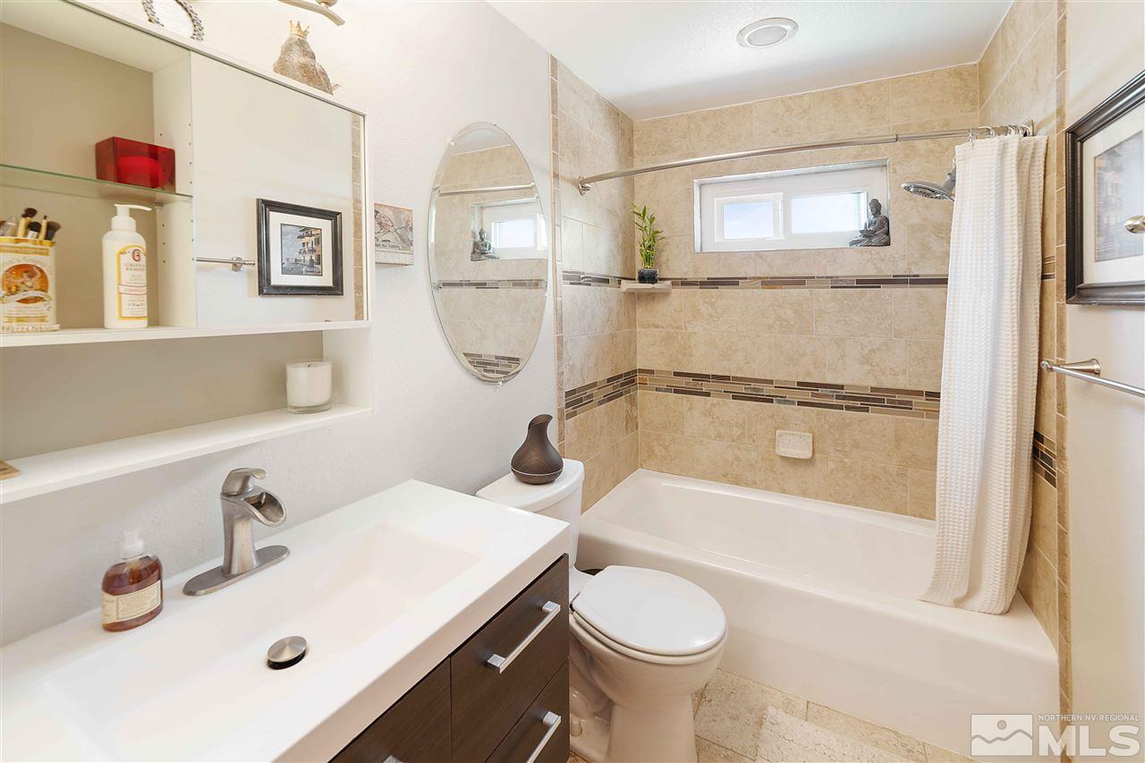 10813 Santa Fe Road Reno, NV 89508 - Photo 19 of 25 a bathroom with a sink mirror vanity and bathtub