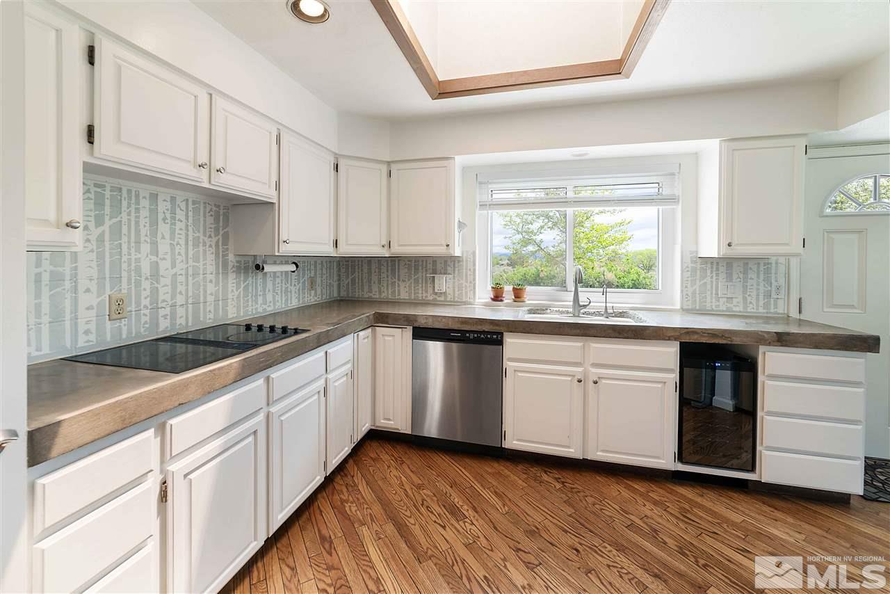 10813 Santa Fe Road Reno, NV 89508 - Photo 8 of 25 a kitchen with granite countertop cabinets stainless steel appliances a sink and a window