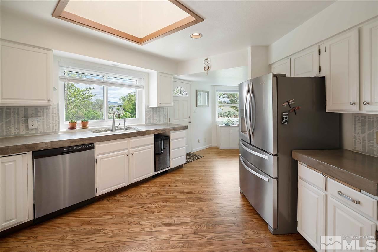 10813 Santa Fe Road Reno, NV 89508 - Photo 9 of 25 a kitchen with stainless steel appliances a refrigerator sink and cabinets