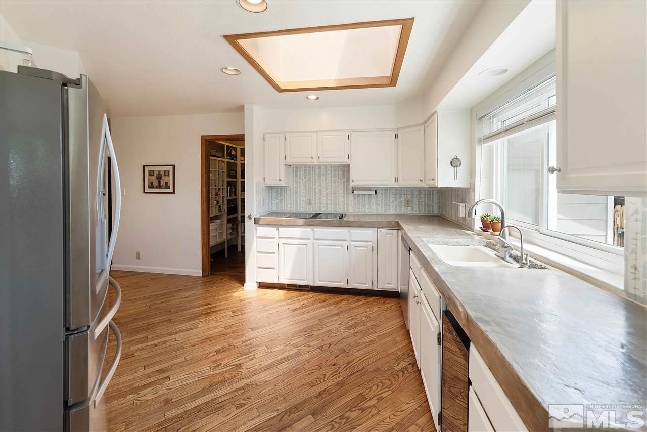 10813 Santa Fe Road Reno, NV 89508 - Photo 10 of 25 a kitchen with a sink a refrigerator and cabinets