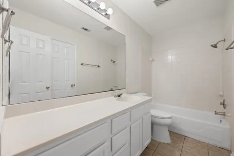 a bathroom with a sink a toilet and bathtub
