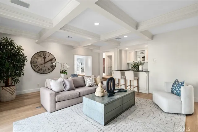 a living room with furniture a clock and a window