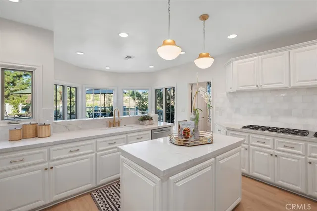a kitchen with a stove and white cabinets