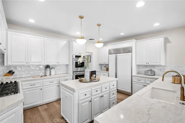 a kitchen with stainless steel appliances a sink stove and refrigerator