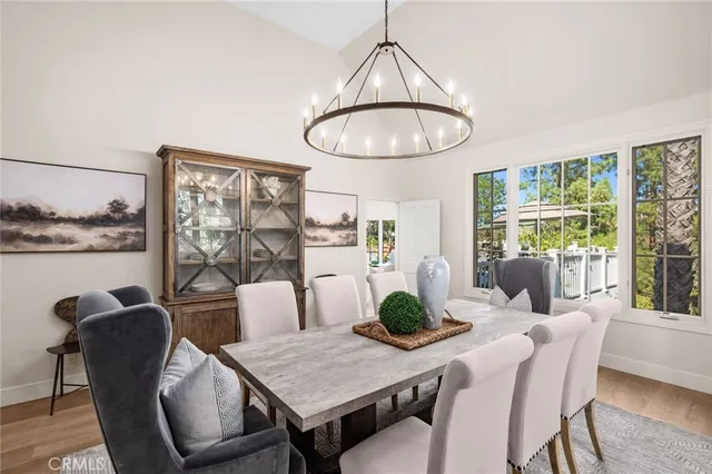 a dining room with furniture window and wooden floor