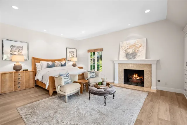 a bedroom with a bed and a fireplace