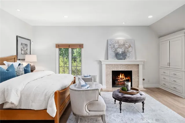 a living room with furniture a fireplace and window