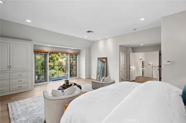 a bedroom with a bed and a large window