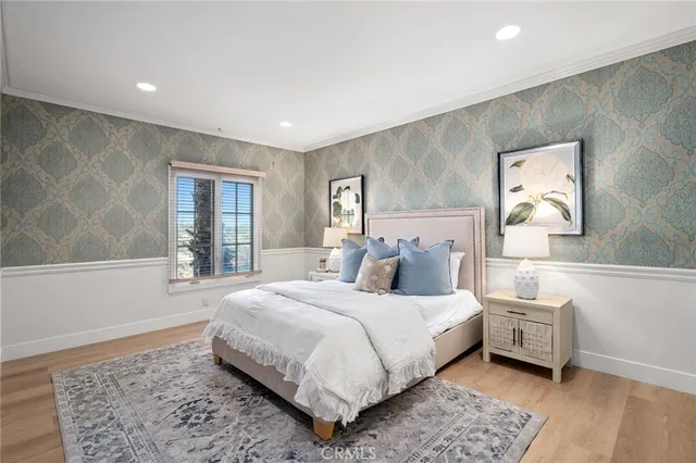 a bedroom with a large bed and a window