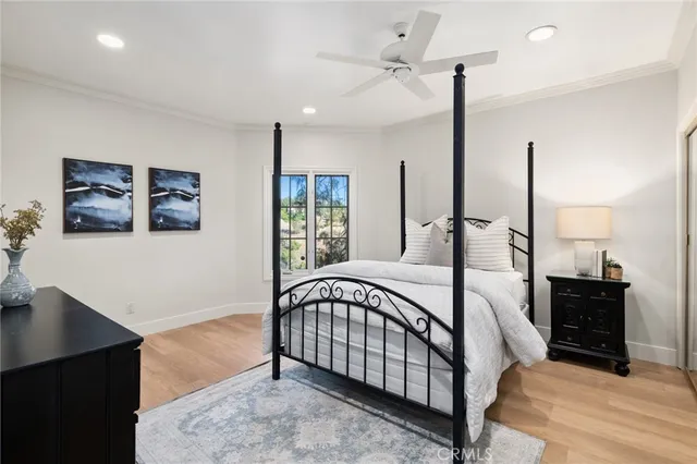 a view of a bedroom with furniture and window
