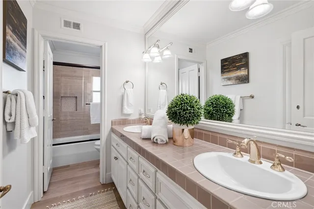 a bathroom with a double vanity sink and a mirror