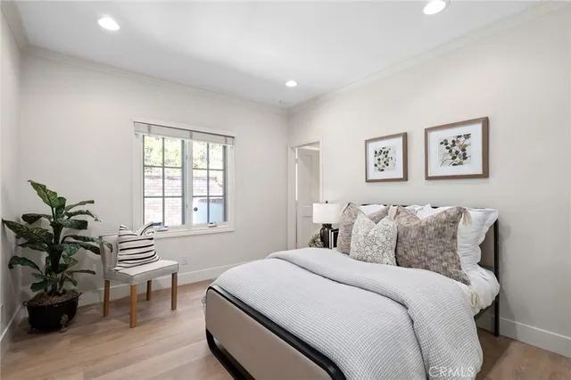 a bedroom with a bed and a potted plant