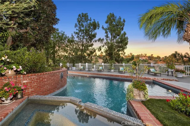 a view of a swimming pool with a patio and a garden