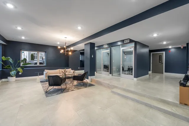 a living room with furniture and a large mirror