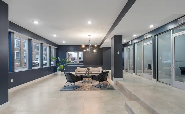 a lobby with furniture and floor to ceiling window