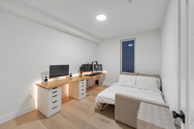 a bedroom with a workspace