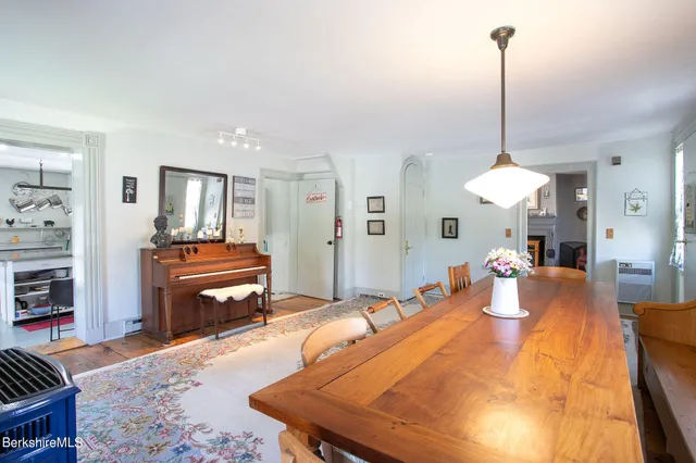 a kitchen with stainless steel appliances granite countertop a sink dishwasher and white cabinets with wooden floor