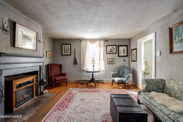 a living room with furniture a rug and a window