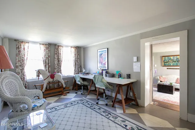 a living room with furniture a table and a large window