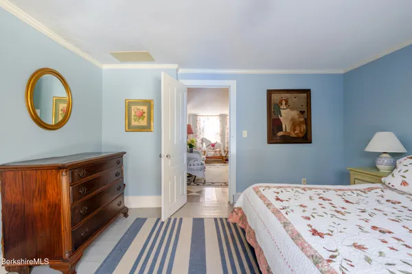 a bedroom with a bed and a flat tv screen