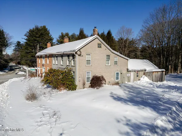 a view of house with outdoor space and garden