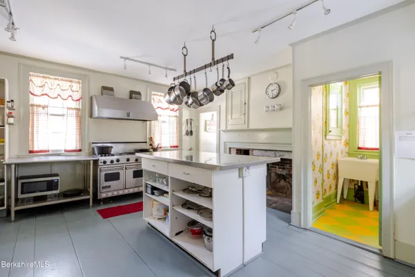 a kitchen with stainless steel appliances granite countertop a stove and cabinets