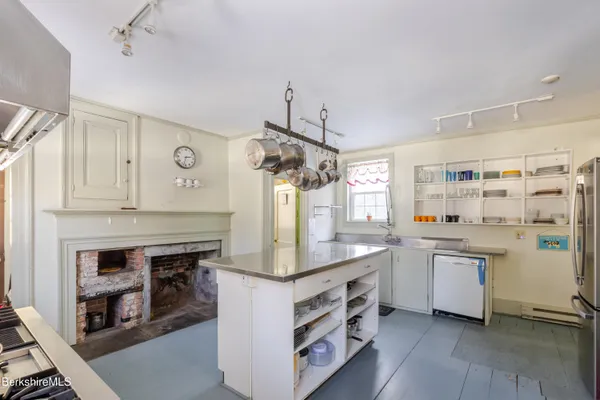 a kitchen with stainless steel appliances granite countertop a sink and a refrigerator