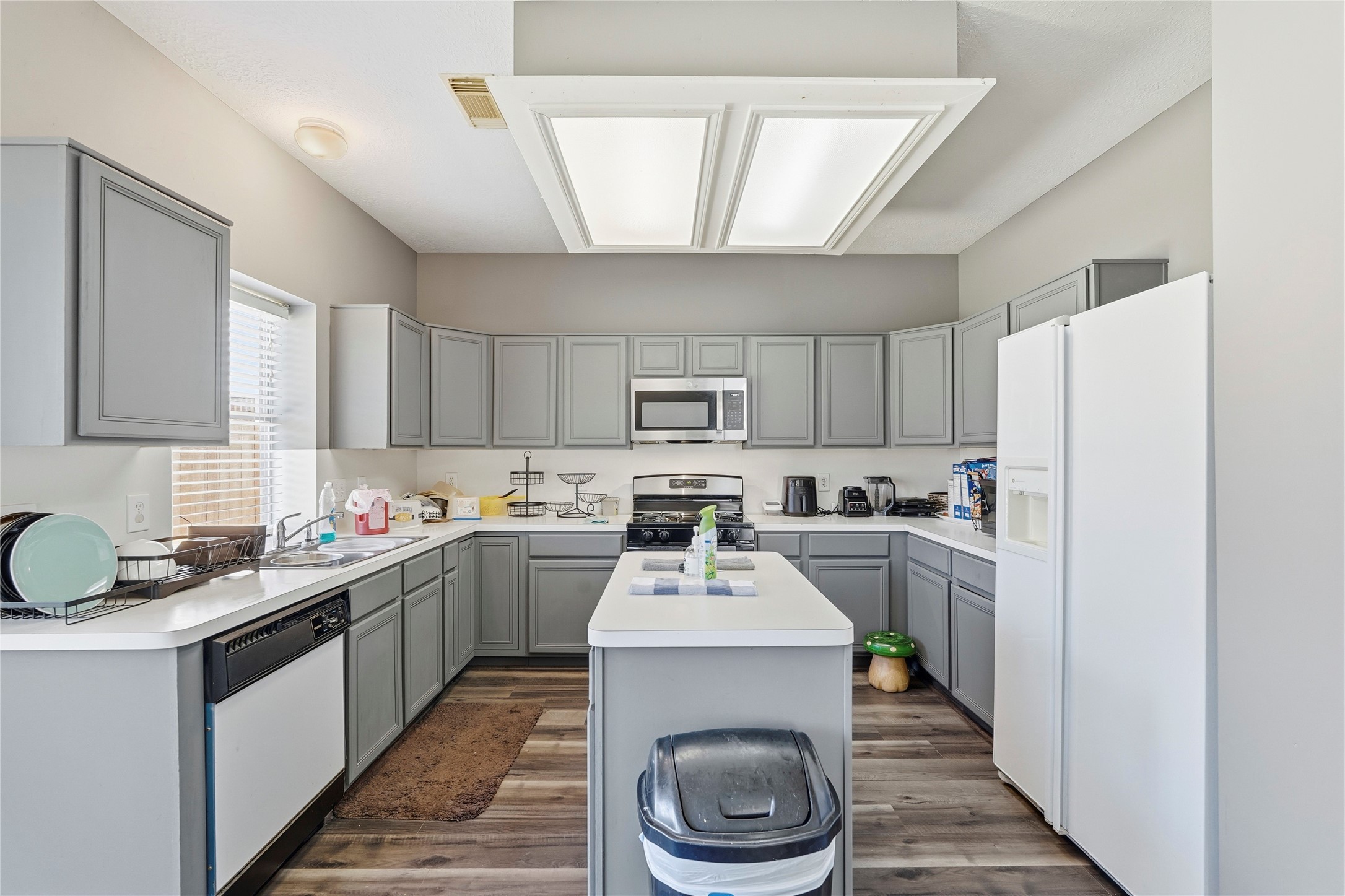 8706 Lone Maple Drive Houston, TX 77083 - Photo 14 of 27 a kitchen with a sink stove and refrigerator